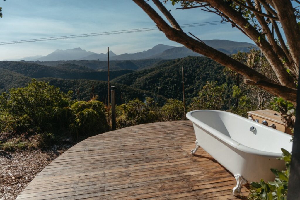 Wooden deck surrounded by mountains highlighting eco-living and nature immersion in Hoekwil at Mountain Magic